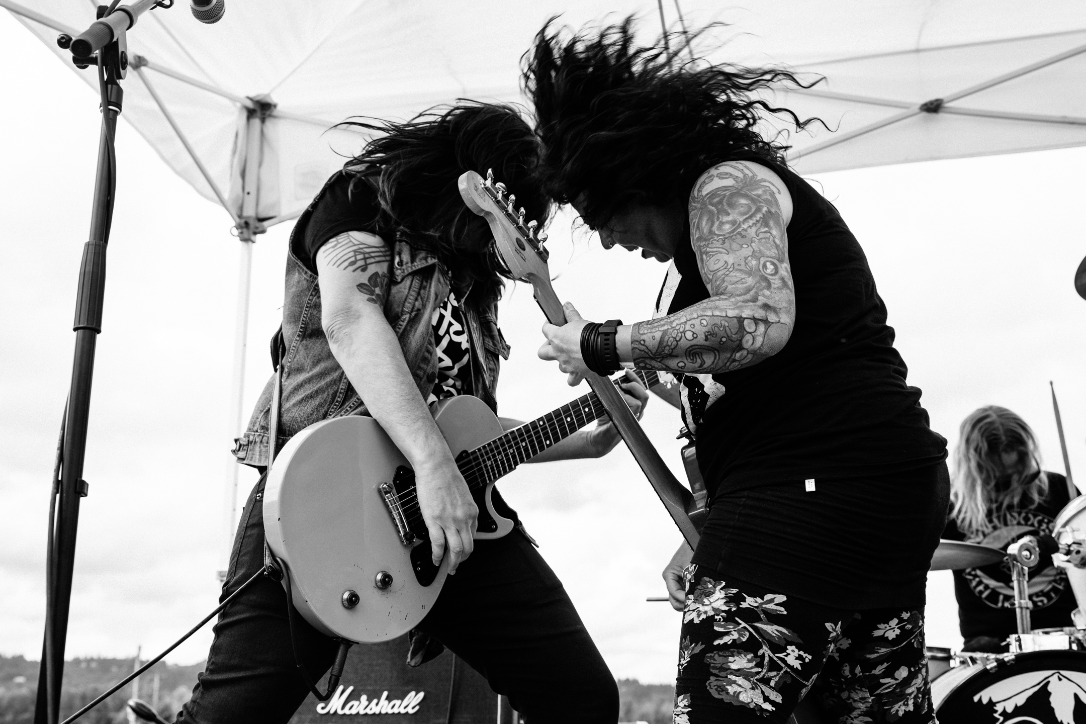 Katie and Squeaky from Year of the Fist rock out on their guitars during a performance