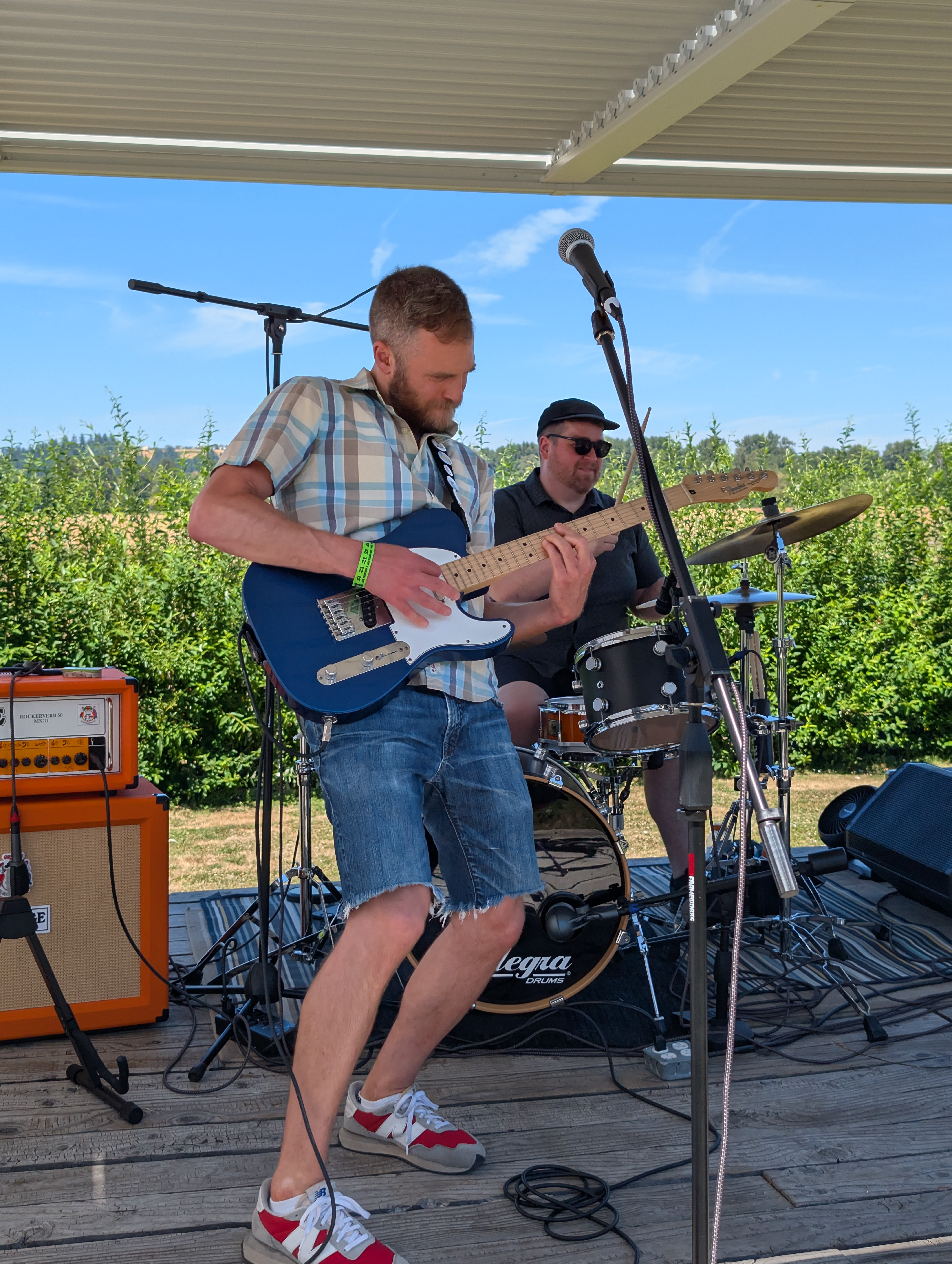 Jeff plays guitar and Simon plays drums while Friends With Salad performs onstage
