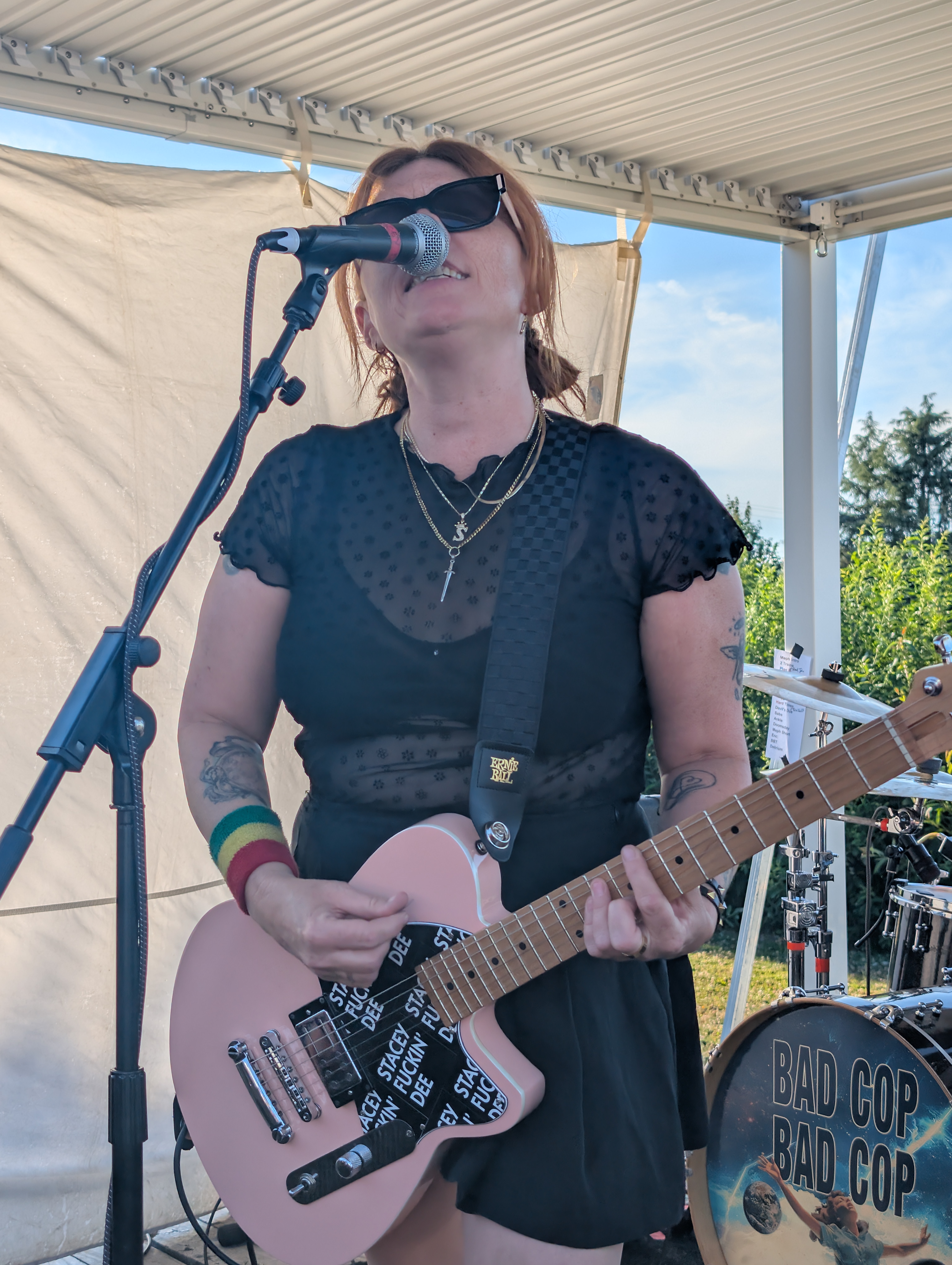 Stacey Dee from Bad Cop/Bad Cop plays guitar and sings on stage